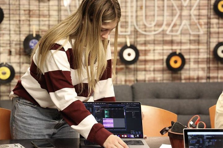Student prepares laptop for audio.